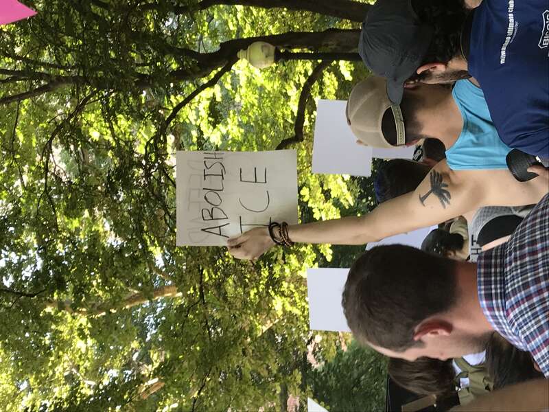 A protester holding a sign that says "abolish ICE" at a protest against immigration and customs enforcement (ICE) in Philadelphia. The protest was specifically against the Trump Administration's "zero tolerance" policy separating children and parents