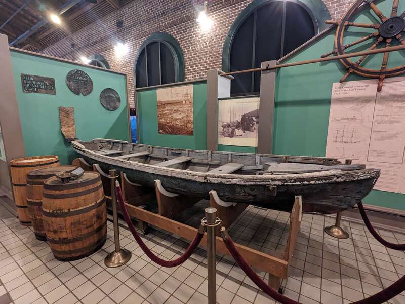 A weathered wooden canoe as part of a display on the Georgia low country