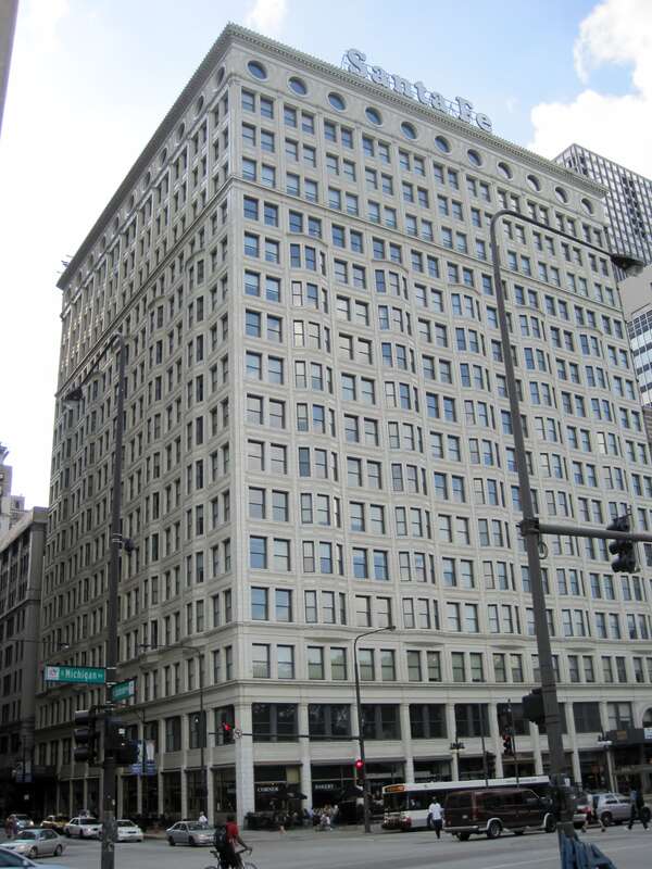 The Railway Exchange Building in Chicago (1904). It was designed by D. H. Burnham &amp; Co. for Burnham. He leased it to the Atchison, Topeka and Santa Fe Railway. Burnham used a suite on the top floor of his building when he was designing the 1909
