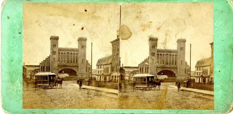 Stereo view looking south at the Eastern Railroad depot in Salem, Massachusetts on Washington Street. People are in view in front of the depot along with a "North &amp; South Salem" horsecar. Circa 1870.