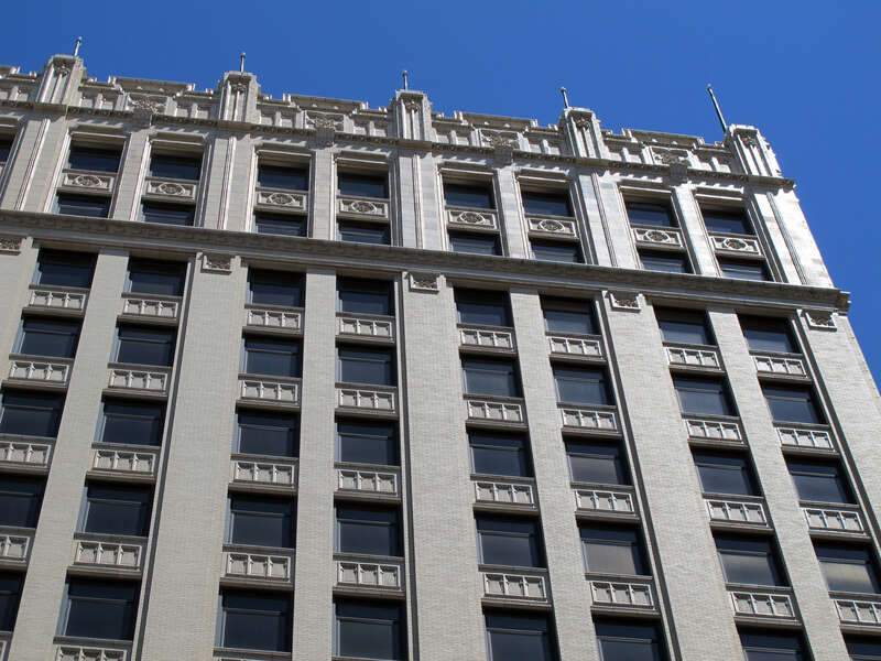 Photo of the upper-level architectural details of the Sharp Building, 206 S. 13th Street, Lincoln, Nebraska.  Photo is of the west side of the building, taken near alleyway south of "N".