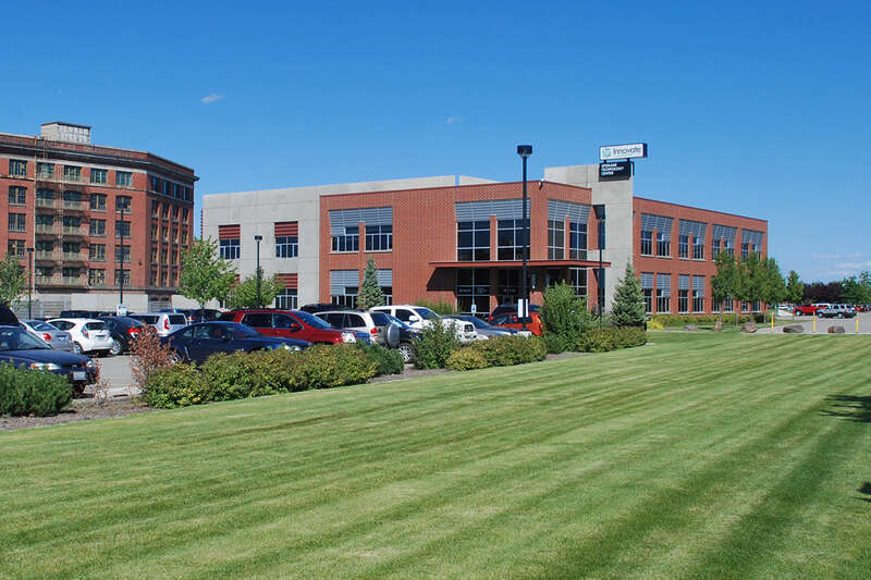 Photo of the Spokane Technology Center building in August 2013 under its Innovate Washington banner.  The building was developed in 2005 by the Spokane Intercollegiate Research &amp; Technology Institute (SIRTI), one of the predecessor agencies that