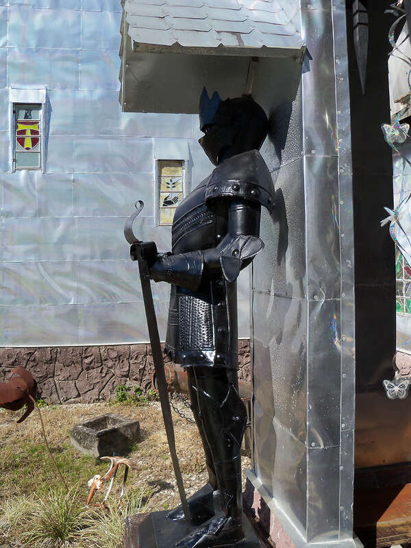 Solomon's Castle in Florida. 
"Castle" built from discarded materials and objects by an eccentric artist in swamps on Ona, Florida; walls are covered with used aluminum printing plates that reflect light.