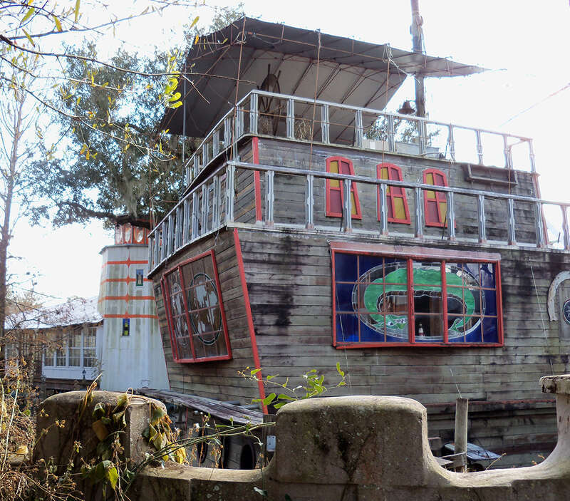 Solomon's Castle in Florida. 
"Castle" built from discarded materials and objects by an eccentric artist in swamps on Ona, Florida; walls are covered with used aluminum printing plates that reflect light.