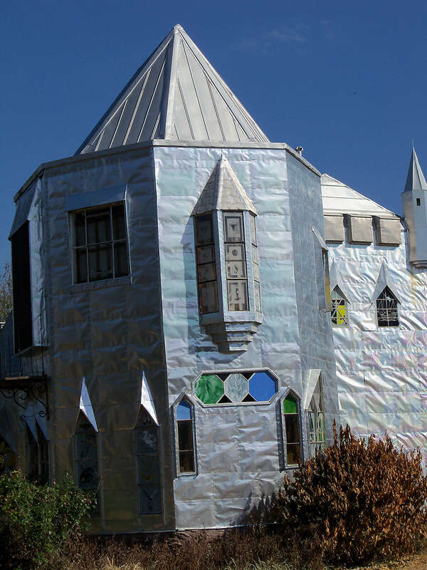 Solomon's Castle in Florida. 
"Castle" built from discarded materials and objects by an eccentric artist in swamps on Ona, Florida; walls are covered with used aluminum printing plates that reflect light.