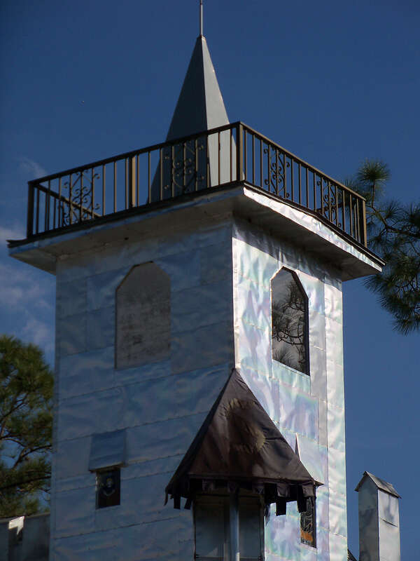 Solomon's Castle in Florida. 
"Castle" built from discarded materials and objects by an eccentric artist in swamps on Ona, Florida; walls are covered with used aluminum printing plates that reflect light.