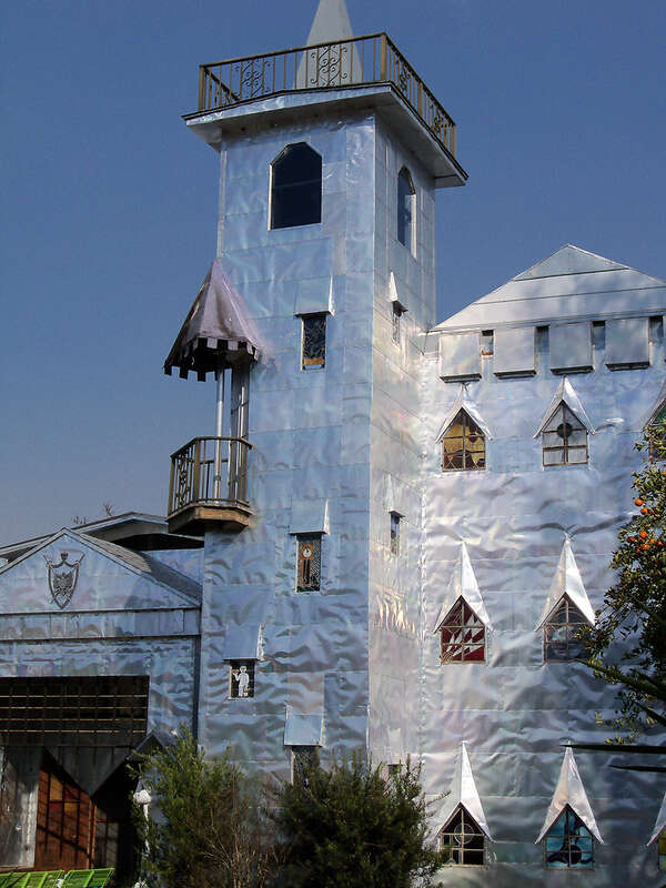Solomon's Castle in Florida. 
"Castle" built from discarded materials and objects by an eccentric artist in swamps on Ona, Florida; walls are covered with used aluminum printing plates that reflect light.