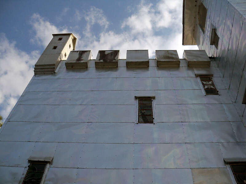 Solomon's Castle in Florida. 
"Castle" built from discarded materials and objects by an eccentric artist in swamps on Ona, Florida; walls are covered with used aluminum printing plates that reflect light.