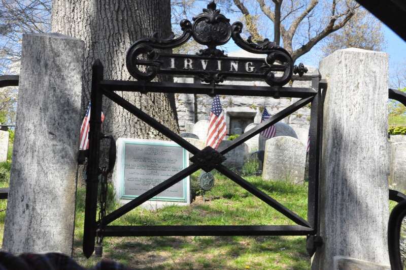 The curved headstone of Washington Irving is seen in the background.