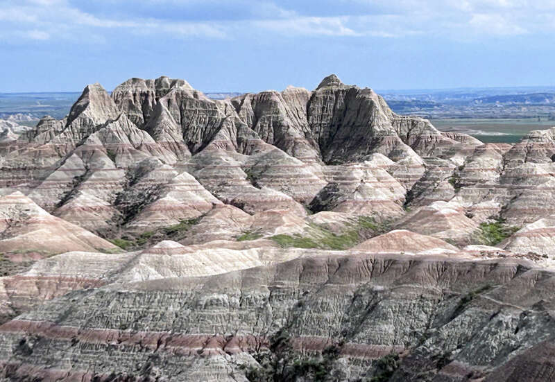 The White River Badlands of South Dakota consist of a scenic landscape of differentially weathered and eroded, nonmarine sedimentary rocks of Tertiary age.  The most visually-striking areas have been set aside as an American national park