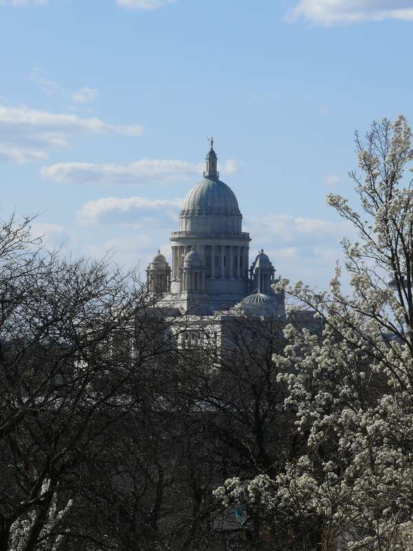 The Rhode Island State House is the capitol of the U.S. state of Rhode Island. It is located on the border of the Downtown and Smith Hill sections of the state capital city of Providence. The State House is a neoclassical building.