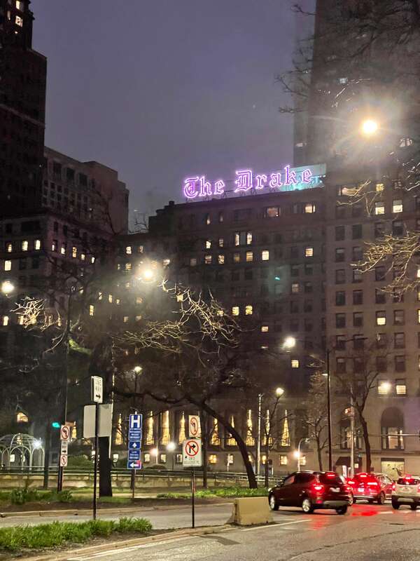 The pink neon sign marks "The Drake," Chicago, Illinois.