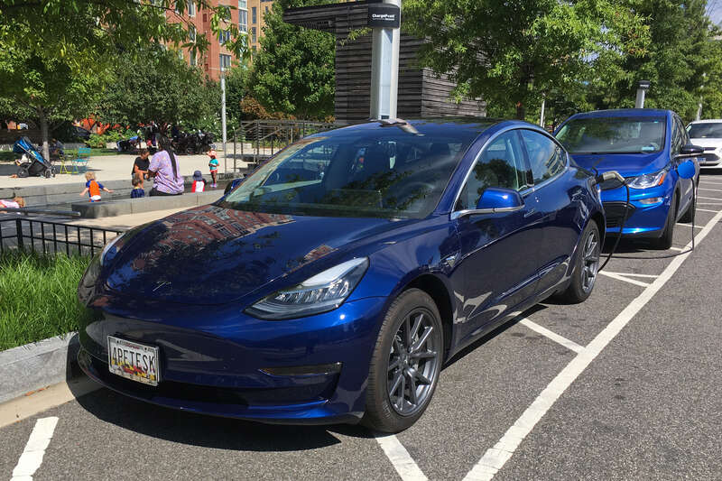 Tesla Model 3 (left) and Chevrolet Bolt EV (right) charging at a ChargePoint on street public charging station. Washington, D.C.