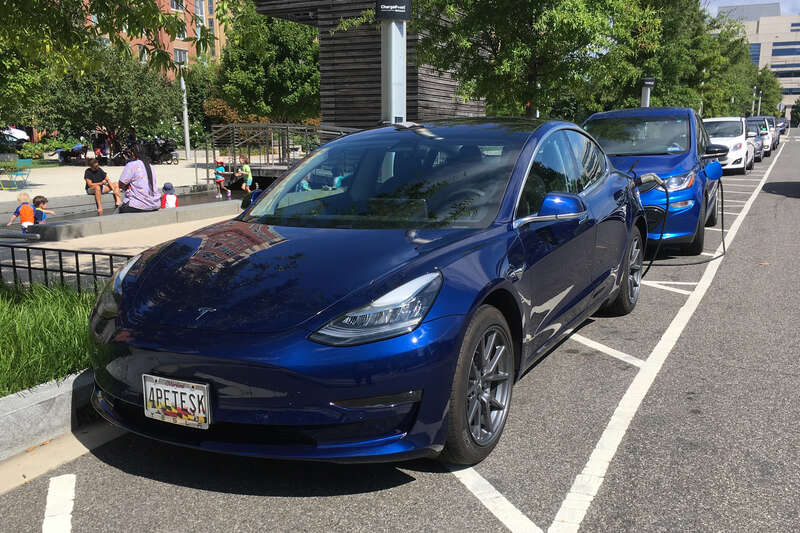 Tesla Model 3 charging at a ChargePoint on street public charging station. Washington, D.C.