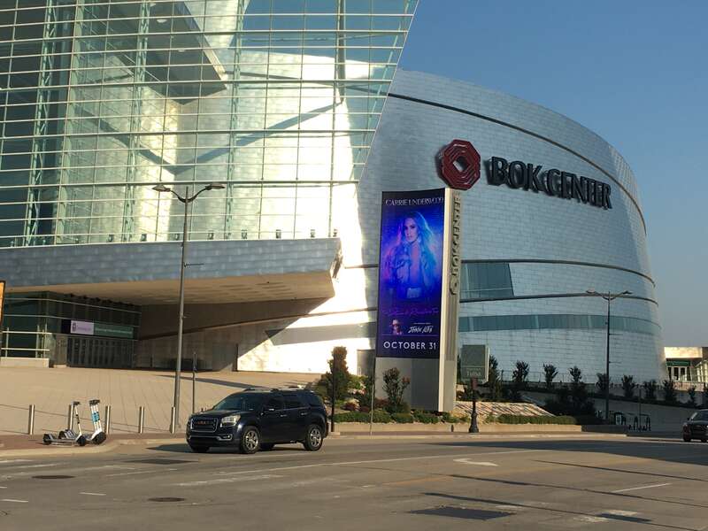 The BOK Center in downtown Tulsa, Oklahoma, during an early morning, with an advertisement on the large electronic marquee of sorts for an upcoming concert by Oklahoman native Carrie Underwood.
