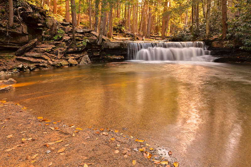 Long exposure waterfall from Swallow Falls State Park in Maryland, USA. HDR composite from multiple exposures. 
For those who might want to use this photo for editorial purposes, please note the waterfall &amp; stepping stones face the opposite