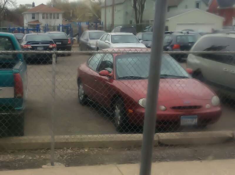 A third-generation Ford Taurus parked at the Community School of Excellence. Photographed in St. Paul, Minnesota, United States of America.
