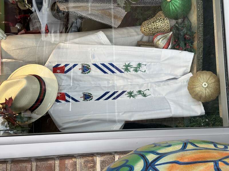 Calle Ocho, Little Havana, Miami, Florida. Hat and Cuban Guayabera shirt in window.