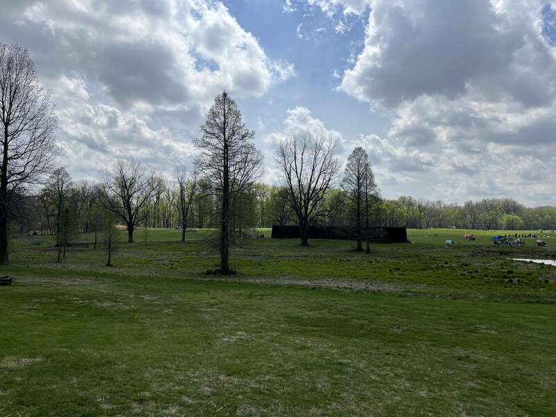 Reconstructed palisade at Angel Mounds State Historic Site as seen from the visitor center. Note the people in the background gathered to watch the Total Solar Eclipse of April 8, 2024.