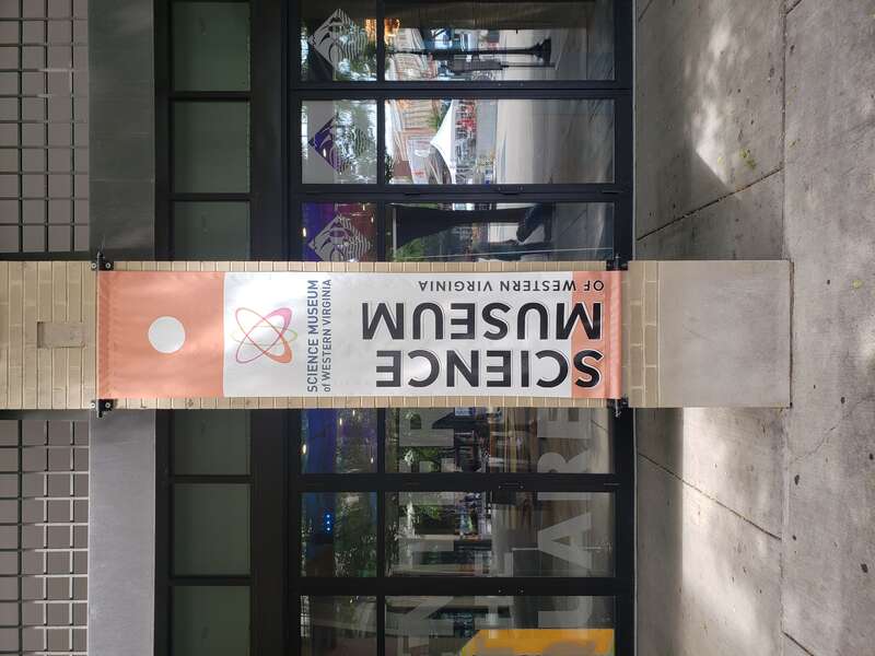 Banner outside the Science Museum of Western Virginia in Roanoke. The banner is on a pillar outside of the museum inside the Market Square of Roanoke.