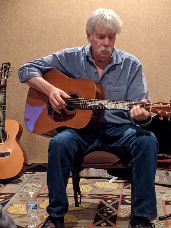 Tom Rush playing guitar in September 2022