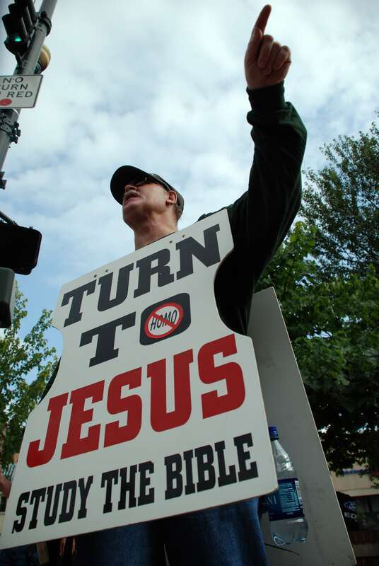In the thick of the Bele Chere street festival, some demonstrators used the occasion to get their message out. It reads: "Turn to Jesus, read the bible"