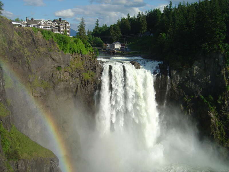 A picture of Snoqualmie Falls in mid-June, with a rainbow in the spray