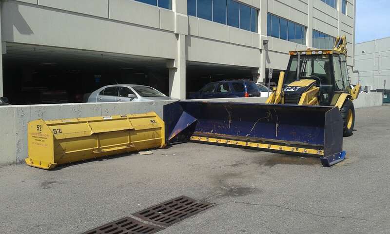 Snow plow loader behind Lakewood Civic Center and South Allison Parkway garage