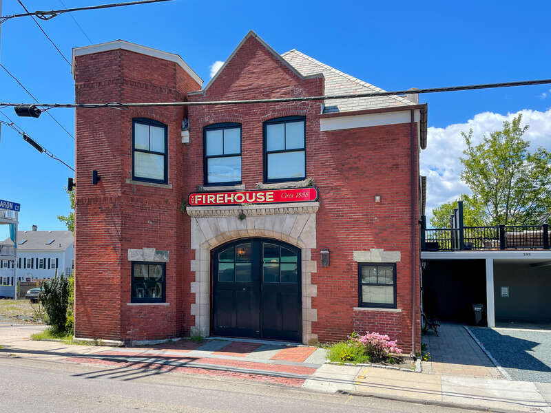 The Firehouse, 595 Thames Street, Newport, Rhode Island. Former firehouse built "around 1888." Originally had a lookout tower. Later converted into a pizzeria and in 2017 was renovated into a vacation rental property.