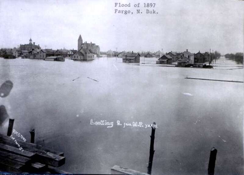 Flood damage resulting from the April 1897 flood of the Red River in Fargo, ND.  The picture was taken from the Northern Pacific rail yards, looking to the southeast.