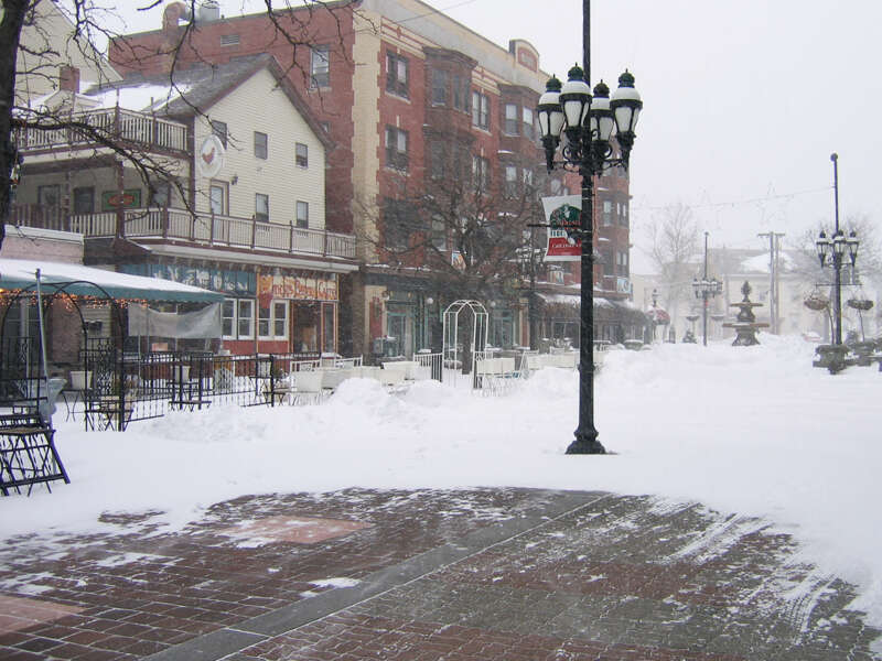 The image was take on March 2, 2009 and shows snow in Providence, Rhode Island. While wind has blown the foreground clean of snow, more snow is seen in the background. There are no people outside, obviously it's cold.