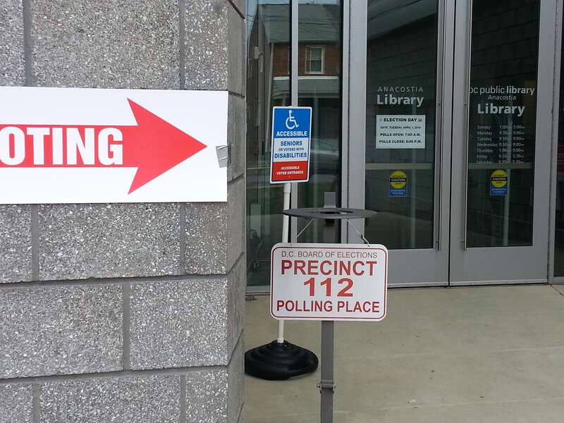 U Place SE entrance to the Anacostia Branch of the D.C. Public Library on primary election day, April 1, 2014.  Big red "VOTING" signs are everywhere.  Note the "Precinct 112 Polling Place" sign, the advice to disabled people or seniors, and the