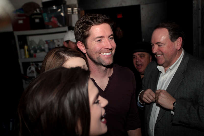 Josh Turner and former Governor Mike Huckabee speaking with supporters at a campaign rally at Wooly's in Des Moines, Iowa.

Please attribute to Gage Skidmore if used elsewhere.