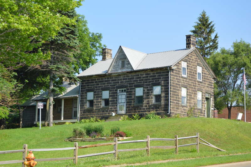 Front and western end of the Phillip Henninger House, located at 5757 Broadview Road (State Route 176) in Parma, Ohio, United States.  Built in 1842, it is listed on the National Register of Historic Places.