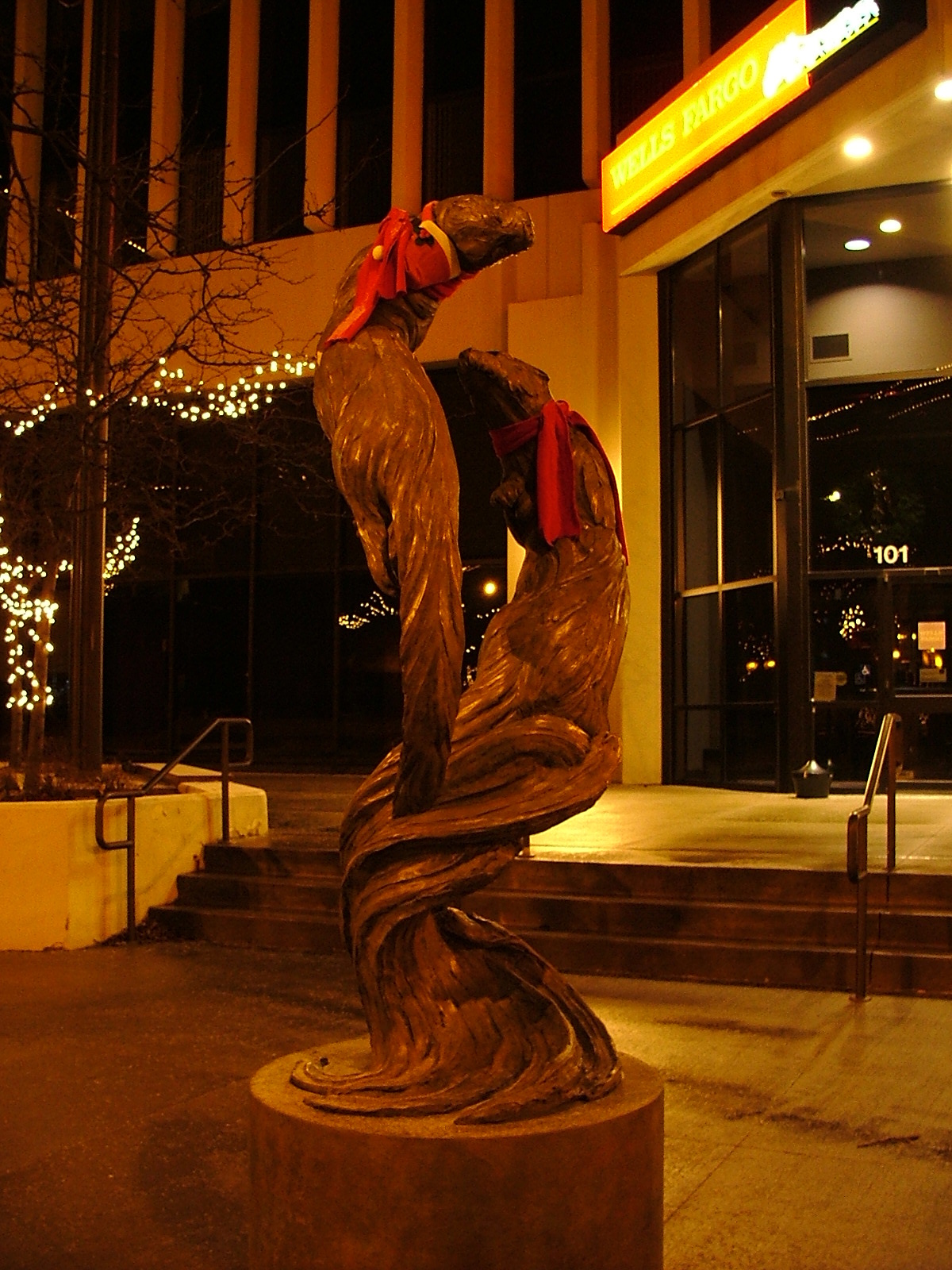 A bronze sculpture of two otters that a humorous soul dressed up for the season in front of the Wells Fargo bank at the corner of Phillips and 9th.