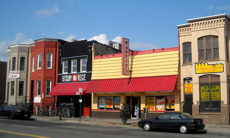 A Popeyes Chicken &amp; Biscuits restaurant, Sticky Rice sushi restaurant, and other commercial properties located on the 1200 block of H Street, N.E., (north side) in the Near Northeast neighborhood of Washington, D.C.  The row houses visible on the