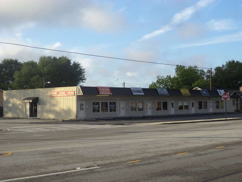 From left to right, the occupants are South Georgia Coin &amp; Supply, Union Holiness Church of God in Christ, Trinity Barber &amp; Beauty Shop, Black Sunshine Games, House of Joy (church), Mr. Fixit (phone repair), 3323 Bemiss Rd, Valdosta, Lowndes