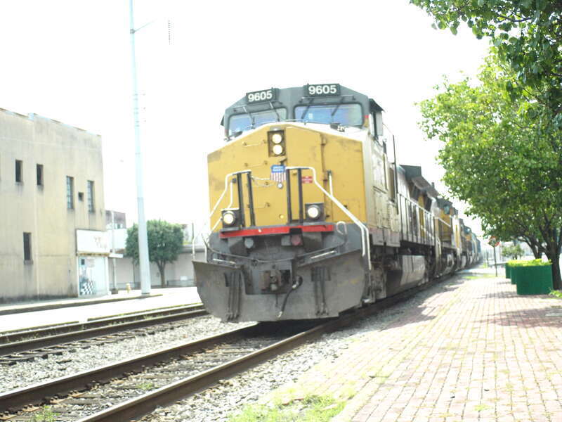 Union Pacific train with power to spare on the head-end rolls through downtown Pine Bluff.  Taken with Olympus E-410 using zuiko 28mm f3.5 lens, camera set on aperture priority mode, iso200.