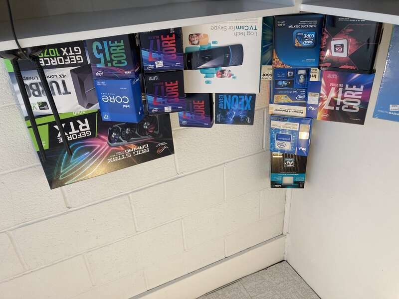 Computer products on top of a shelf.