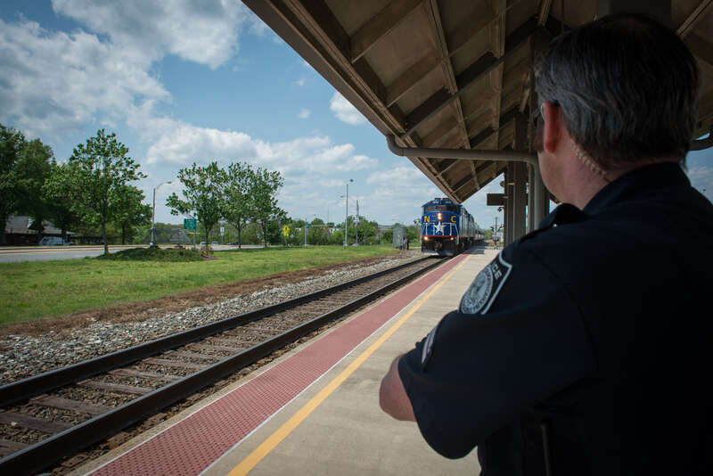 A police officer watches a special train at Burlington station in April 2015
