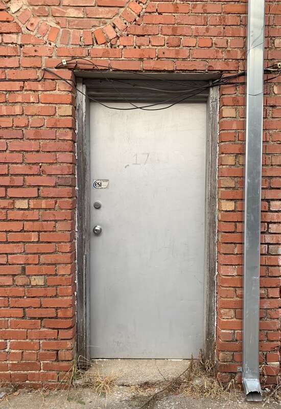 Back door of a store opening onto a quiet back street in Edmond, Oklahoma, USA