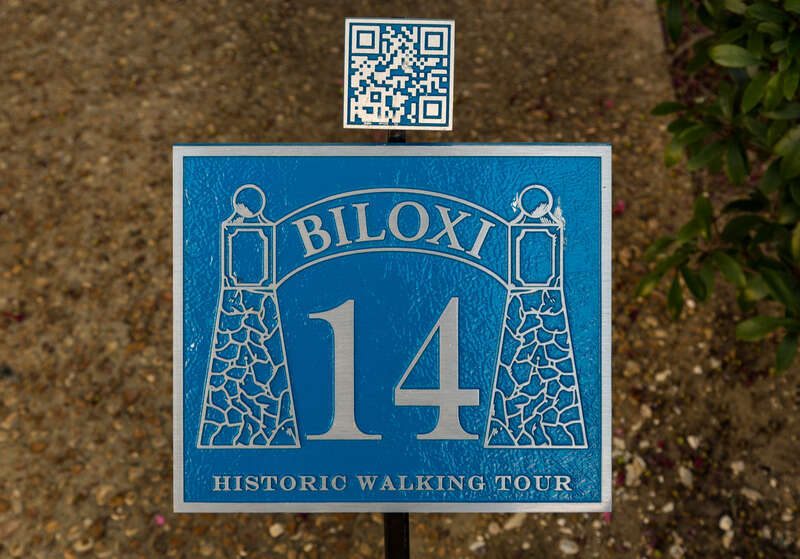 A sign with a QR code near Howard Avenue &amp; Rue Magnolia for a historic walking tour, in Biloxi, Mississippi.