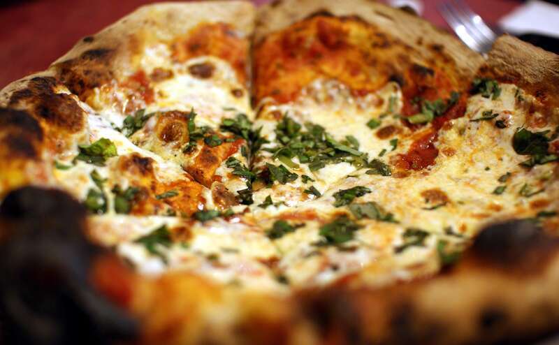 A Margarita pizza from Zeffiro's (from a different angle—yes, this pizza deserved two photos!). Just the basics: tomatoes, mozzarella, and basil. From Las Cruces' new bakery/pizza joint, Zeffiro. It took much too long for a brick-oven pizza place to