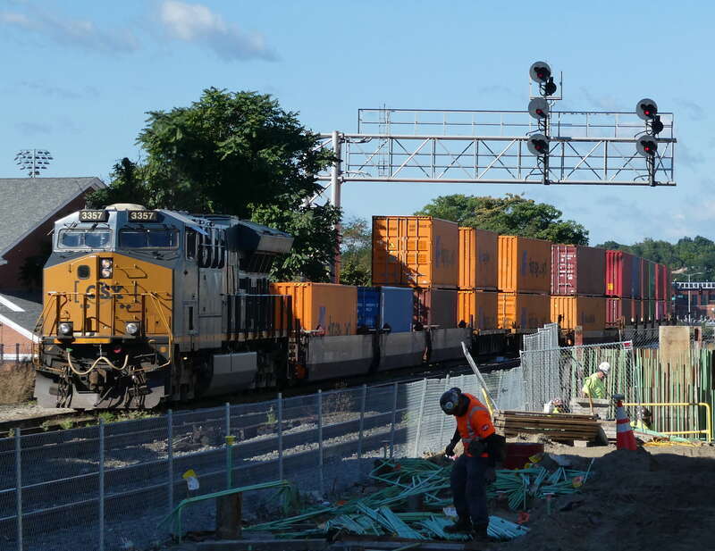 A CSX freight passing Worcester Union Station in September 2022. Construction work for the tunnel to the second platform is visible at bottom right.