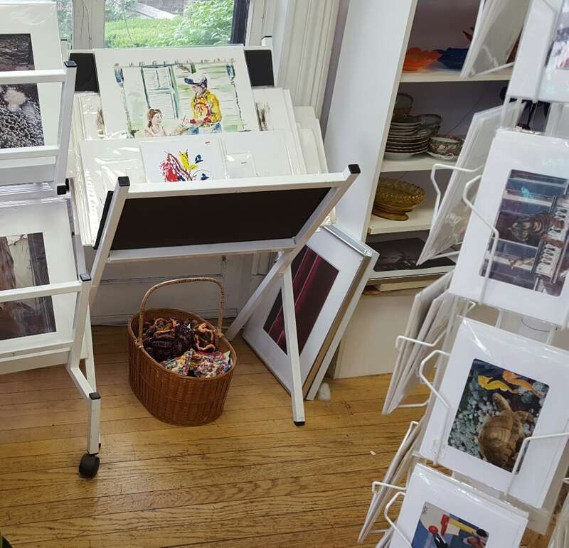 The Capital District Tourism Gnome buys some artwork at the National Upholstery on Lark Street in Albany, New York.