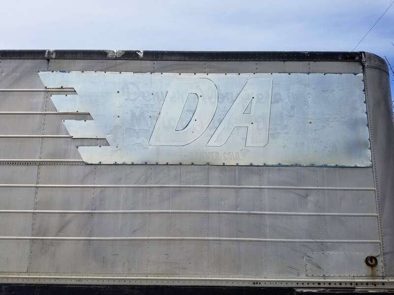 Sign on trailer, "DA, Denver Albuquerque Motor Transport, Denver, Colo.", parked in Adams County, CO.