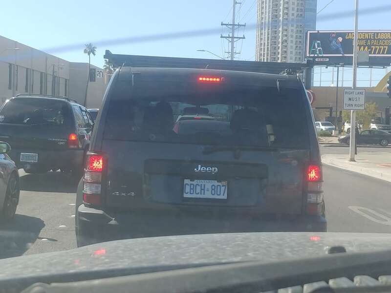 A dark-grey 2010 Jeep Liberty stopped on East Sahara Avenue in Las Vegas, Nevada. It has an Ontario registration plate.