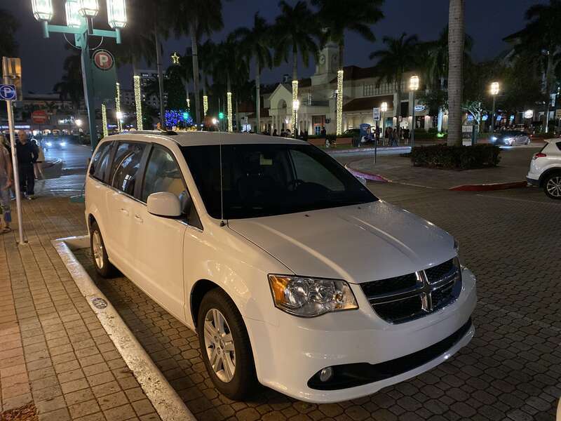 Dodge Grand Caravan (RT) STX trim photographed at night in Mizner Park, Boca Raton, Florida. Front view of this minivan finished in "White Knuckle" clear coat.