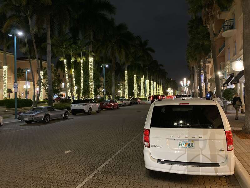 View of East Plaza Real (facing north) at night in Mizner Park, Boca Raton, Florida. Alsom the rear of a parked Dodge Grand Caravan (RT) with STX trim and finished in "White Knuckle" clear coat.