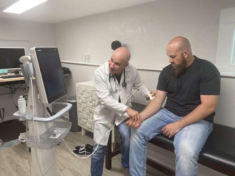 Dr. Lee Moorer At Castle Rock Mens Health with a person for Check Up
